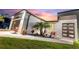 Eye-catching contemporary home boasting a dark front door and meticulous rock and plant landscaping at 24470 Kingsway Cir, Punta Gorda, FL 33983