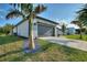 Exterior view of the garage with decorative rock feature at 24470 Kingsway Cir, Punta Gorda, FL 33983