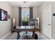 Bright home office featuring modern decor, a large window, and contemporary desk setup at 24470 Kingsway Cir, Punta Gorda, FL 33983
