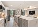 Open-concept kitchen featuring a gray island, stainless steel appliances, and a view of the living area at 24470 Kingsway Cir, Punta Gorda, FL 33983
