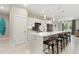 Modern kitchen featuring a waterfall island with seating, stainless steel appliances, and stylish pendant lighting at 24470 Kingsway Cir, Punta Gorda, FL 33983