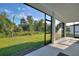 Relaxing lanai with screened-in porch and views of the lush backyard at 24470 Kingsway Cir, Punta Gorda, FL 33983