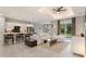 Open-concept living room adjacent to a modern kitchen with bar seating, ideal for entertaining and everyday living at 24470 Kingsway Cir, Punta Gorda, FL 33983