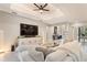 Large living room featuring a tray ceiling, a large television, recessed lights, and an open floor plan at 24470 Kingsway Cir, Punta Gorda, FL 33983