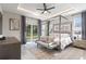 Spacious main bedroom featuring a canopy bed, sitting area, and outdoor views at 24470 Kingsway Cir, Punta Gorda, FL 33983
