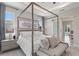 Bright main bedroom with a canopy bed, sitting area, and stylish decor at 24470 Kingsway Cir, Punta Gorda, FL 33983