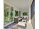 Inviting covered patio featuring stylish seating arrangements and decorative wall plants at 24470 Kingsway Cir, Punta Gorda, FL 33983