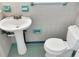 Traditional bathroom featuring a pedestal sink, and toilet against tiled walls at 301 Francis Dr, Apollo Beach, FL 33572