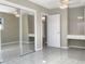 Bedroom with tile floors, ceiling fan, built in vanity and mirrored sliding door closet at 301 Francis Dr, Apollo Beach, FL 33572