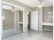 Bedroom with tile floors, ceiling fan, built in vanity and mirrored sliding door closet at 301 Francis Dr, Apollo Beach, FL 33572