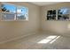 Bedroom with tile floors, two windows bringing in natural light and neutral walls at 301 Francis Dr, Apollo Beach, FL 33572