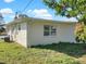 Exterior view of home with small windows surrounded by green lawn and an overgrown bush at 301 Francis Dr, Apollo Beach, FL 33572