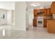 Open floor plan featuring the kitchen with a white refrigerator and brown cabinetry at 301 Francis Dr, Apollo Beach, FL 33572