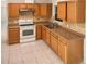 Well-lit kitchen featuring wood cabinets, tile backsplash, and modern appliances at 301 Francis Dr, Apollo Beach, FL 33572
