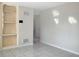 Living room featuring tile flooring, built-in shelving, and neutral paint at 301 Francis Dr, Apollo Beach, FL 33572