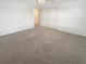 Bedroom featuring neutral carpet, a ceiling fan, a closet, and access to other rooms at 32100 Pop Ash Pl, San Antonio, FL 33576