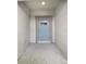 View of light blue front door entryway with light gray trim and concrete flooring at 32100 Pop Ash Pl, San Antonio, FL 33576