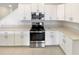 Bright kitchen with stainless steel appliances, white cabinetry and ample countertop space at 32100 Pop Ash Pl, San Antonio, FL 33576