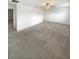 Spacious living room features neutral carpet, a ceiling fan, and access to other rooms at 32100 Pop Ash Pl, San Antonio, FL 33576