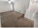 Upstairs living room featuring neutral carpet, white trim, and lots of natural light at 32100 Pop Ash Pl, San Antonio, FL 33576