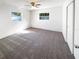 Bedroom with carpet, ceiling fan, and two windows providing natural light, complemented by a closet at 6440 22Nd S St, St Petersburg, FL 33712