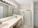 Bathroom features a double sink vanity, a large mirror, and a glass-enclosed shower at 1110 Mcdaniel St # 1110, Sun City Center, FL 33573