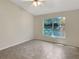 Cozy bedroom with tile flooring, a ceiling fan, and a window with a view of the outdoors at 1110 Mcdaniel St # 1110, Sun City Center, FL 33573