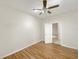 Bright bedroom featuring wood floors, ceiling fan, and a doorway leading to another room at 1110 Mcdaniel St # 1110, Sun City Center, FL 33573