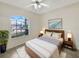 Inviting bedroom featuring a comfortable bed, stylish decor, and a large window overlooking the yard at 1110 Mcdaniel St # 1110, Sun City Center, FL 33573