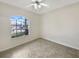 Bright, minimalist bedroom featuring tile floors and a large window offering a view of the outdoors at 1110 Mcdaniel St # 1110, Sun City Center, FL 33573
