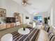 Bright living room with tile floors, modern furnishings, and seamless access to the dining area at 1110 Mcdaniel St # 1110, Sun City Center, FL 33573