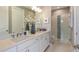 Modern bathroom with double sinks, sleek fixtures, and a glass-enclosed shower for a spa-like experience at 3165 Alba Cir, Bradenton, FL 34211