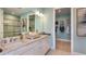 Bathroom featuring double sinks, granite countertops, and walk-in shower at 3165 Alba Cir, Bradenton, FL 34211