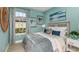 Serene bedroom with blue walls, comfortable bedding, and natural light streaming through the window at 3165 Alba Cir, Bradenton, FL 34211