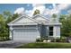 Charming single-story home featuring a two-car garage and a beautifully landscaped front yard, enhancing curb appeal at 3165 Alba Cir, Bradenton, FL 34211