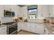 Bright kitchen with stainless steel appliances, white cabinetry, and granite countertops at 3165 Alba Cir, Bradenton, FL 34211