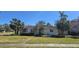 Charming one-story home featuring a landscaped lawn, tiled roof, and mature palm trees at 515 Snell Isle Ne Blvd, St Petersburg, FL 33704