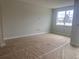 Bedroom with large windows, gray walls, white trim and temporary floor covering to protect new wood-look tile at 7268 Deer Valley Circle, Tampa, FL 33635