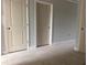 A bedroom with multiple painted paneled doors and base trim, ready for flooring and furnishings at 7268 Deer Valley Circle, Tampa, FL 33635