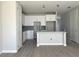 Modern kitchen features new white cabinets, gray backsplash, quartz countertops, eat-in breakfast bar, and wood-look tile at 7268 Deer Valley Circle, Tampa, FL 33635