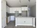 Modern kitchen features new white cabinets, gray backsplash, quartz countertops and eat-in breakfast bar at 7268 Deer Valley Circle, Tampa, FL 33635