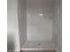 New tiled shower with glass door and built-in shelf, offering a modern and functional bathroom feature at 7268 Deer Valley Circle, Tampa, FL 33635
