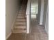 View of the unfinished staircase with carpet removed and open access to the upper floor of the home at 7268 Deer Valley Circle, Tampa, FL 33635