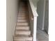 Image of a new stairway with painted walls, newel posts, and wooden handrail leading to the upper level at 7268 Deer Valley Circle, Tampa, FL 33635