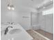 Bathroom featuring double sinks, a glass-enclosed shower with a bench, and modern fixtures at 1067 Signet, Apollo Beach, FL 33572