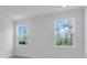 Bright bedroom featuring two windows, neutral paint, and a spacious layout at 1067 Signet, Apollo Beach, FL 33572