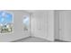 Bright bedroom with two windows, double doors, and a clean, minimalist design at 1067 Signet, Apollo Beach, FL 33572