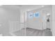 Upstairs hallway featuring neutral paint, natural light, and access to bedrooms and bathrooms at 1067 Signet, Apollo Beach, FL 33572
