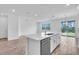 Bright kitchen featuring an island, stainless steel appliances, white cabinets, and tile flooring at 1067 Signet, Apollo Beach, FL 33572