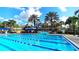 View of the pool featuring lap lanes and waterslide, with a lighthouse structure in the background at 1067 Signet, Apollo Beach, FL 33572